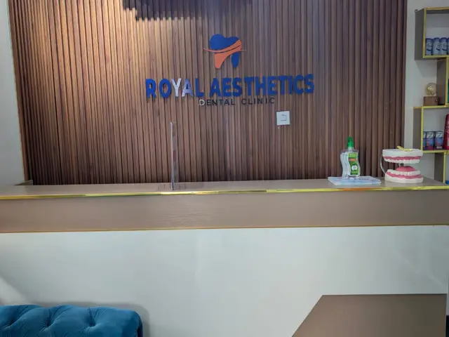 Royal Aesthetics Dental Clinic logo wall in the Magboro reception