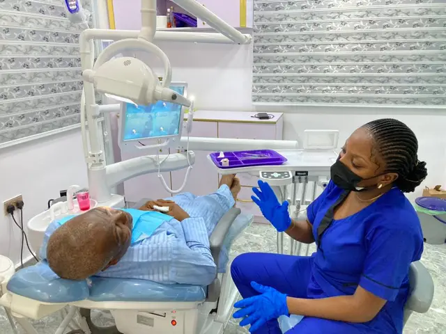 Dentist explaining treatment to a patient in the chair